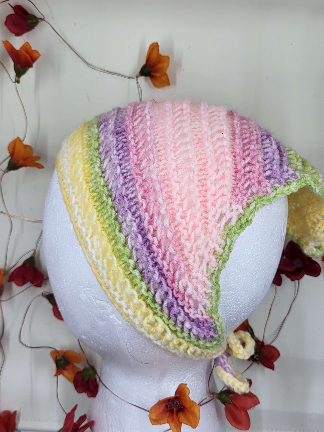 Knit Bandana in pastel colors displayed on a mannequin head, perfect for any elegant occasion.