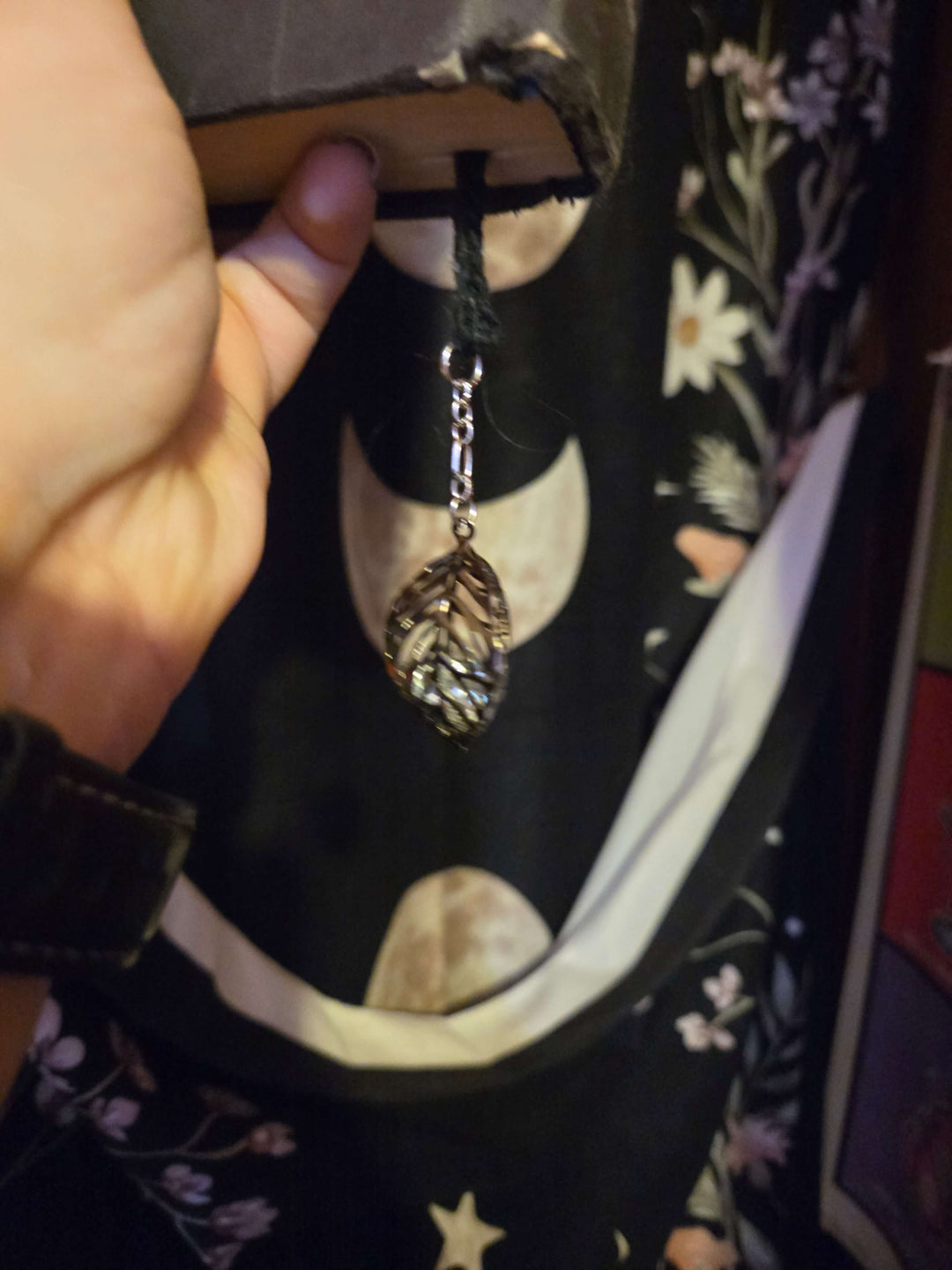 Bookmark featuring a leaf charm attached to a book, blending beauty with functionality for avid readers.