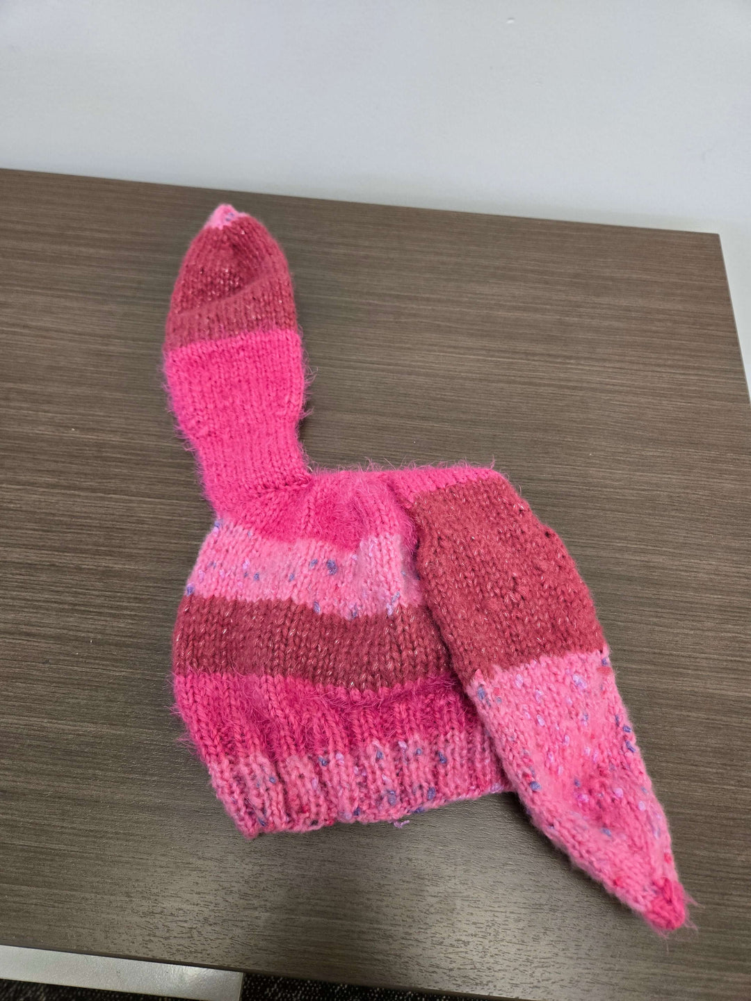 Bunny Hat in pink with long ears, made from a multi fiber blend, perfect for warmth and cuteness.